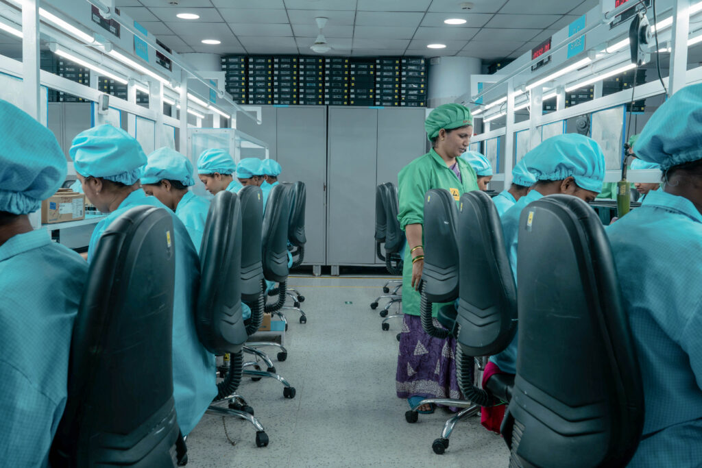 Employees assembling electronic components in assembly line Mumbai