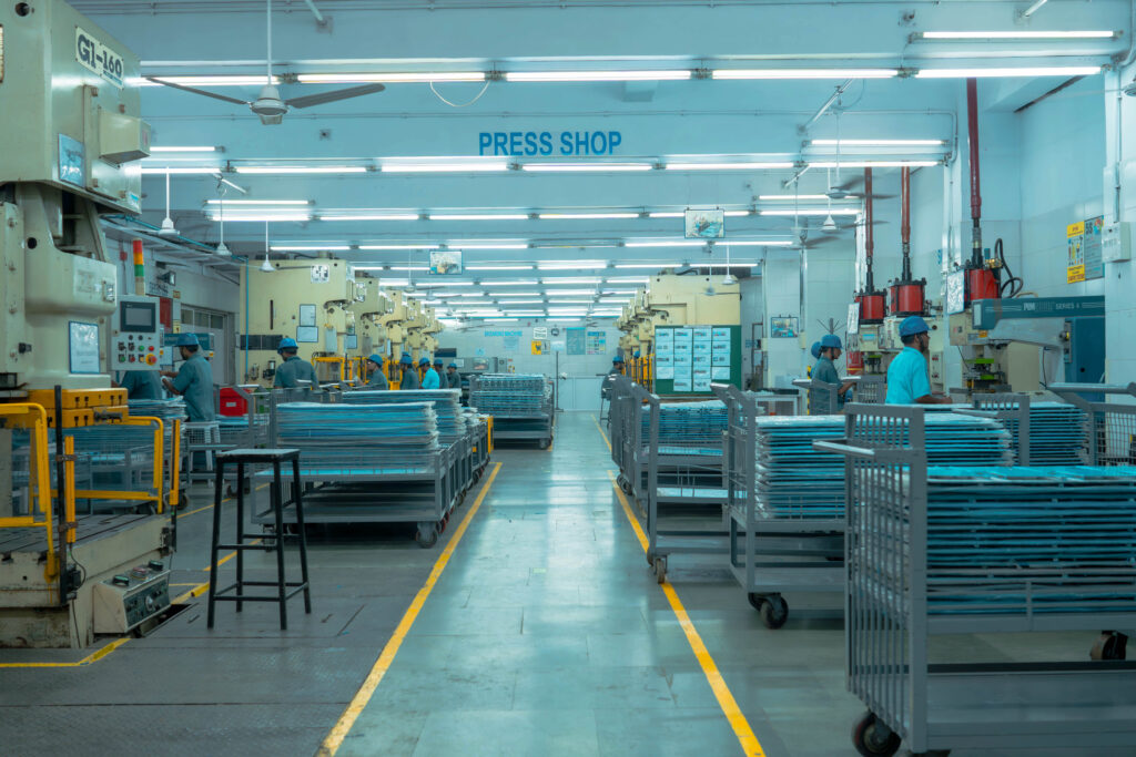 Wide view of press shop machinery and workers in manufacturing unit