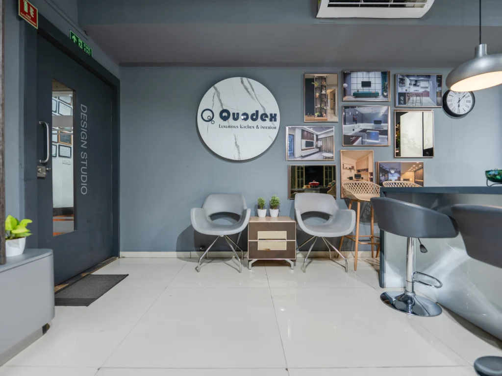 Quodex interior design studio showroom with display frames, modern seating, and reception area
