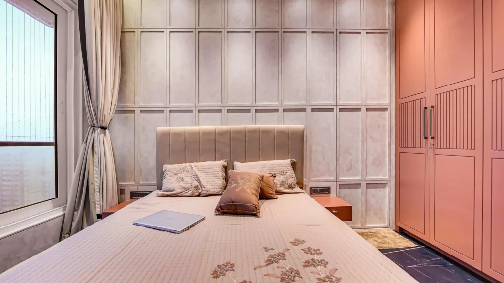 Luxury bedroom interior with custom wall paneling, upholstered bed, built-in wardrobes, and warm lighting