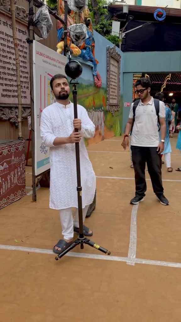 Cinematic360 operator holding Insta360 Pro 2 on carbon fiber monopod at Lalbaug Sarvajanik Utsav Mandal Ganesh Galli Mumbai