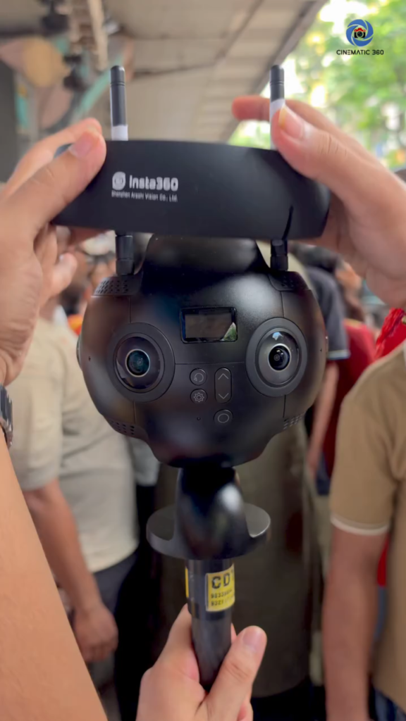 Insta360 Pro 2 camera on compact monopod during live outdoor crowd 360 videography production at Mumbai festival